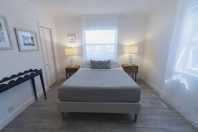 a bedroom with a bed and window