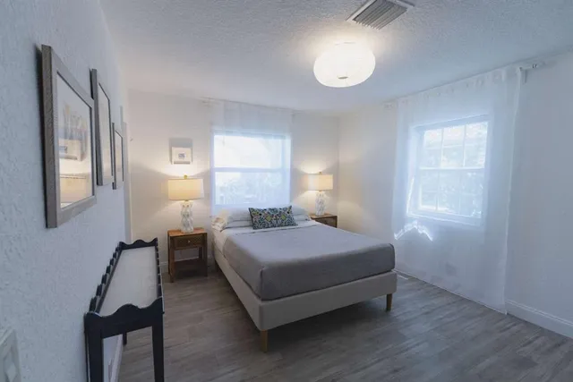 a bedroom with a bed and window