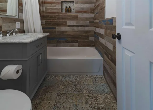 a bathroom with a granite countertop sink a toilet and bathtub
