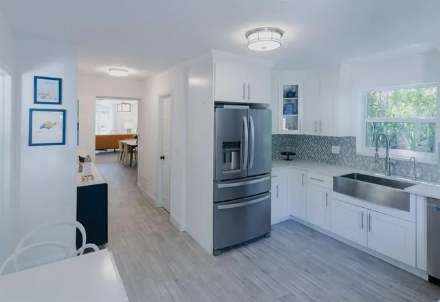 a kitchen with a refrigerator and a sink