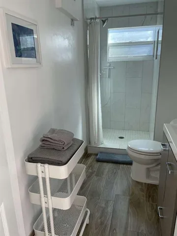 a bathroom with a toilet a sink and shower