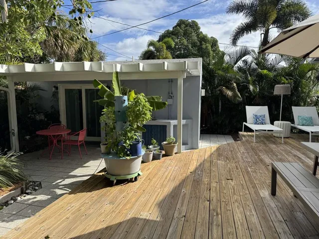a view of a house with sitting area and potted plants