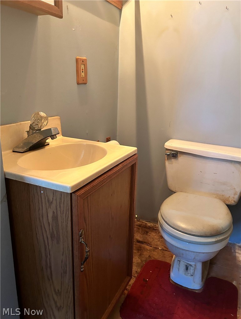 576 High Bridge Road Vermilion, OH 44089 - Photo 7 of 11 Bathroom featuring vanity, toilet, and tile floors