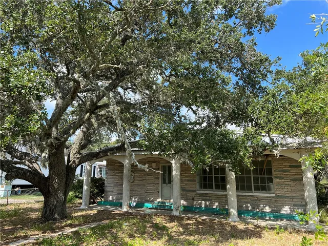 front view of a house with a tree