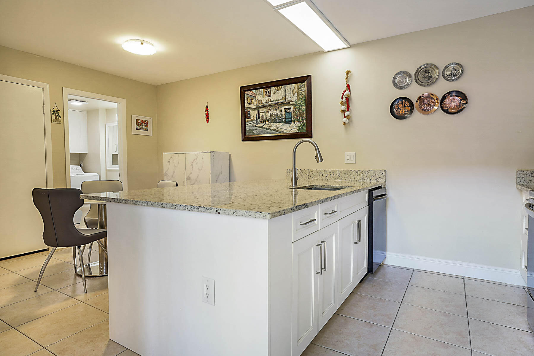 3071 30th Court Jupiter, FL 33477 - Photo 20 of 51 a bathroom with a granite countertop sink a mirror and a bathtub