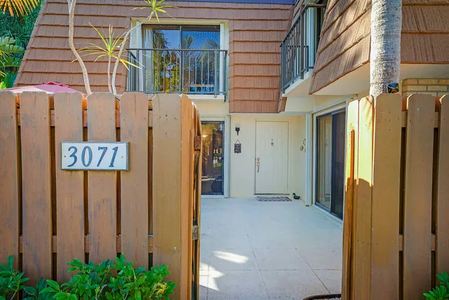 a view of a brick house with a door and wooden door