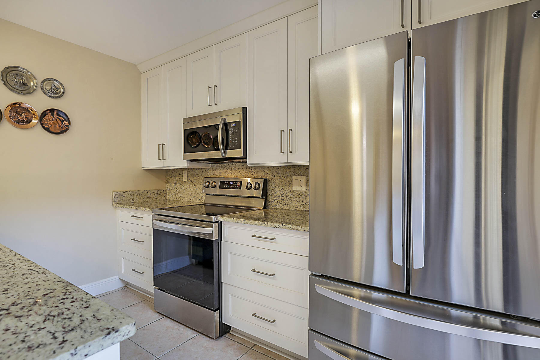 3071 30th Court Jupiter, FL 33477 - Photo 22 of 51 a kitchen with stainless steel appliances a refrigerator stove and microwave