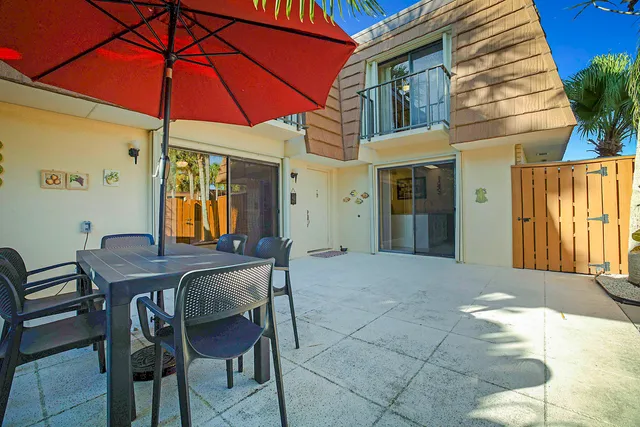 a patio with a table and chairs