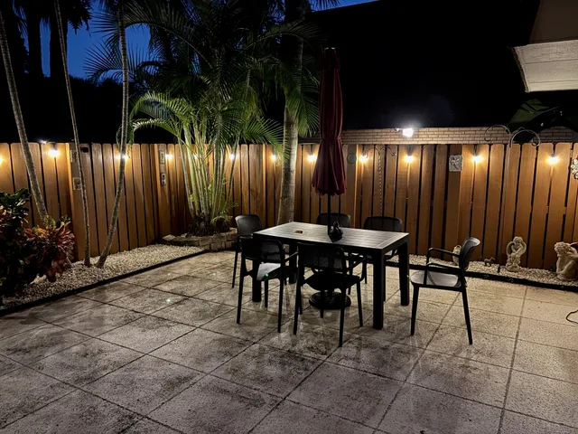 a view of a chairs and table in a patio
