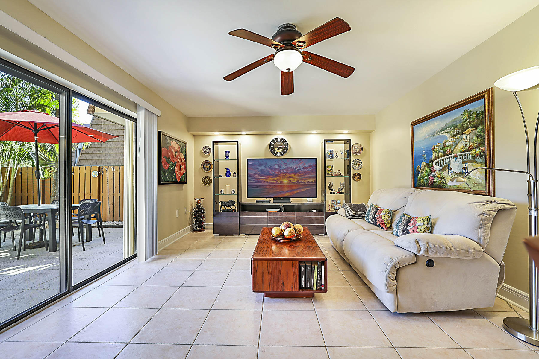 3071 30th Court Jupiter, FL 33477 - Photo 4 of 51 a living room with furniture a floor to ceiling window and a flat screen tv