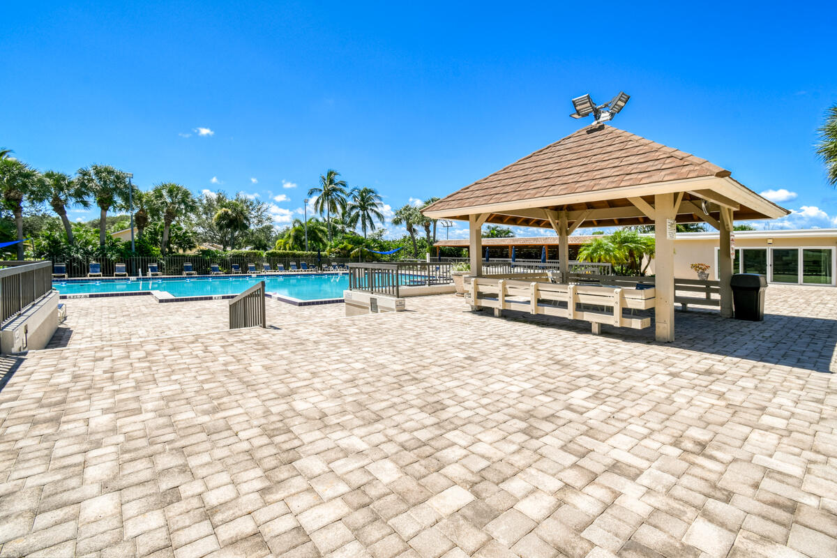 3071 30th Court Jupiter, FL 33477 - Photo 43 of 51 a view of pool with outdoor seating