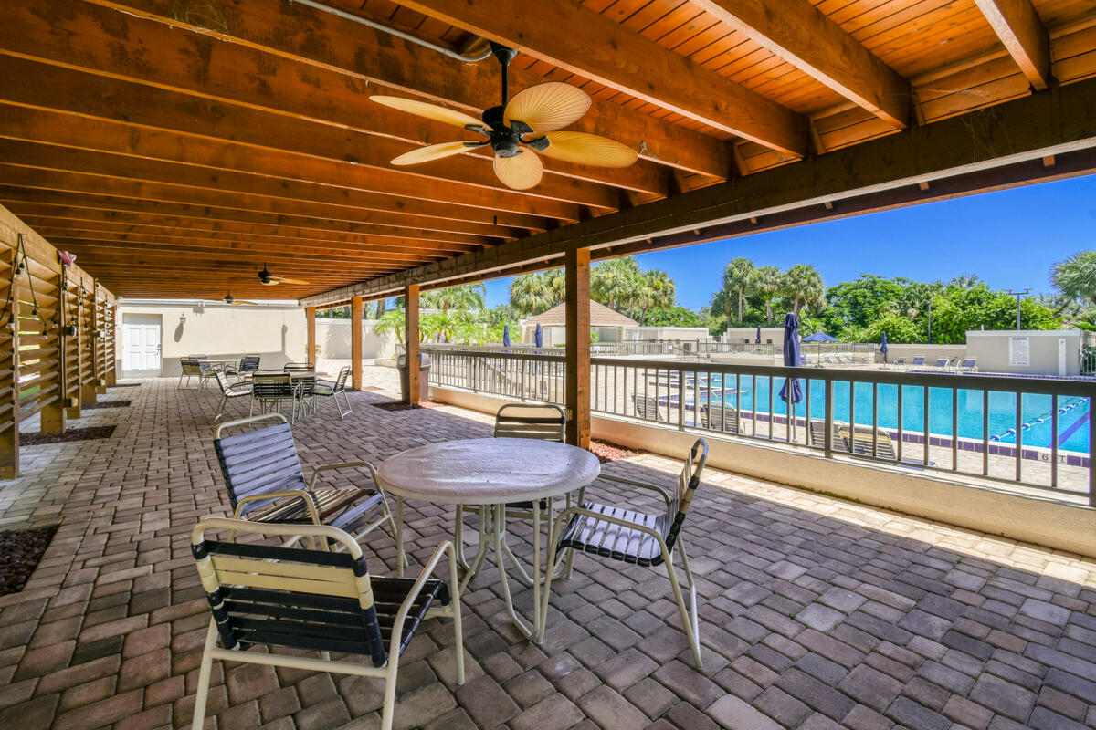 3071 30th Court Jupiter, FL 33477 - Photo 48 of 51 a view of a patio with a table and chairs