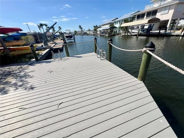 an aerial view of ocean and residential houses with outdoor space
