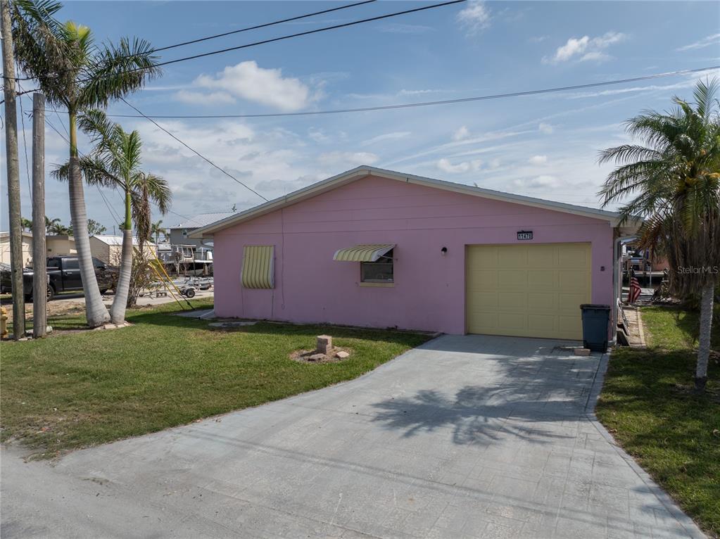 11476 May Street Matlacha, FL 33993 - Photo 18 of 43 a front view of a house with a yard