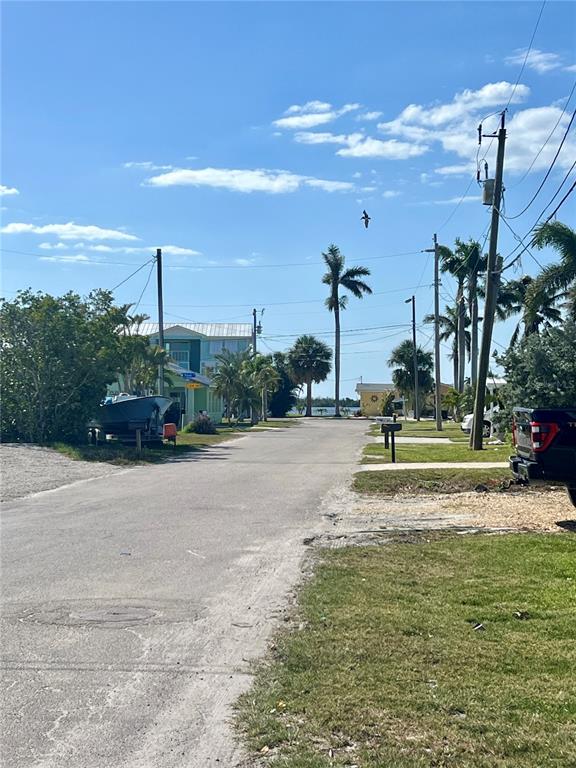 11476 May Street Matlacha, FL 33993 - Photo 23 of 43 a view of a park with swings and slides