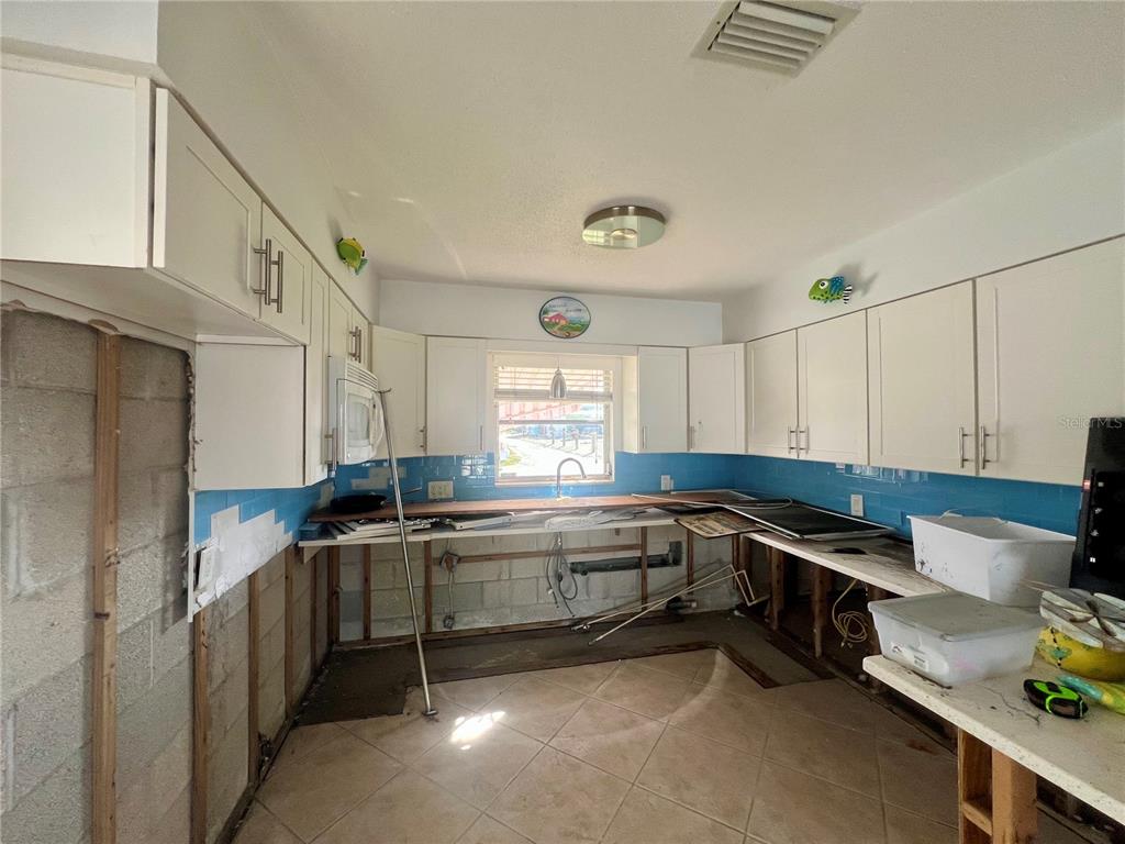 11476 May Street Matlacha, FL 33993 - Photo 32 of 43 a kitchen that has a sink and cabinets