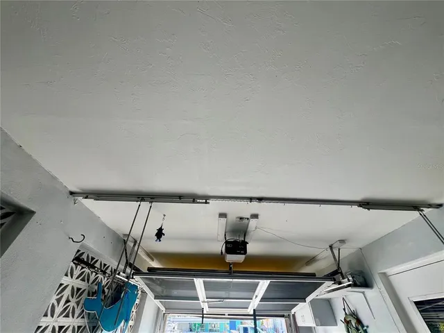 a view of a room that has a large window and brick walls