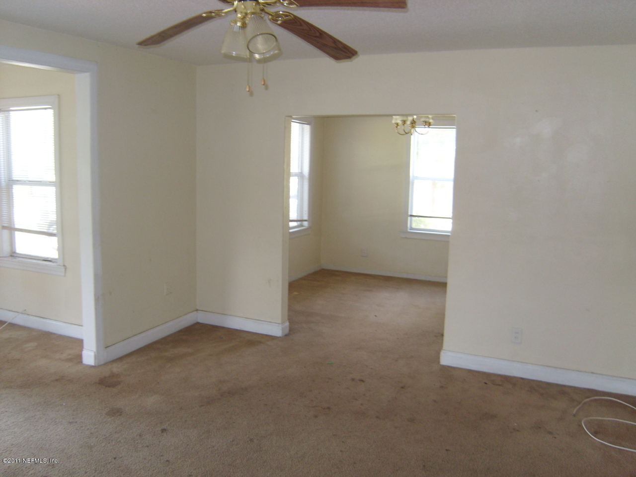 2219 Bayview Road Jacksonville, FL 32210 - Photo 6 of 11 an empty room with windows and fan