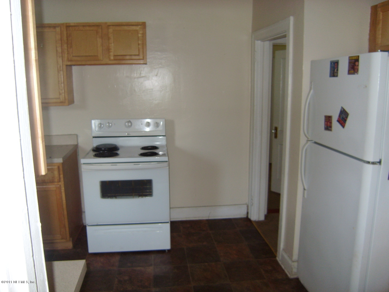 2219 Bayview Road Jacksonville, FL 32210 - Photo 8 of 11 a white refrigerator freezer and a stove sitting inside of a kitchen