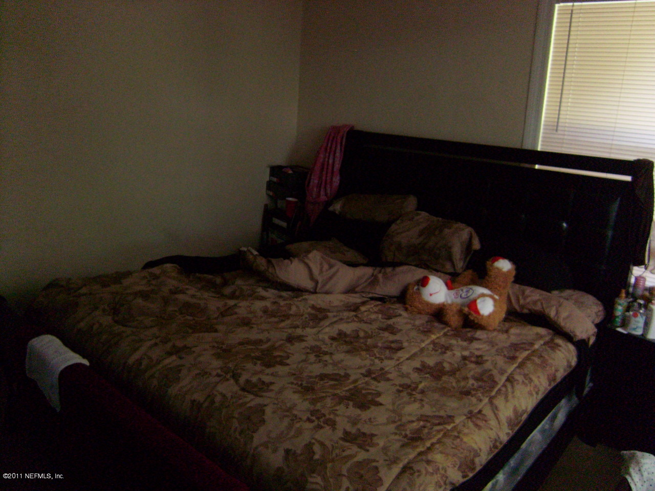 2219 Bayview Road Jacksonville, FL 32210 - Photo 9 of 11 a bed sitting in a bedroom next to a window