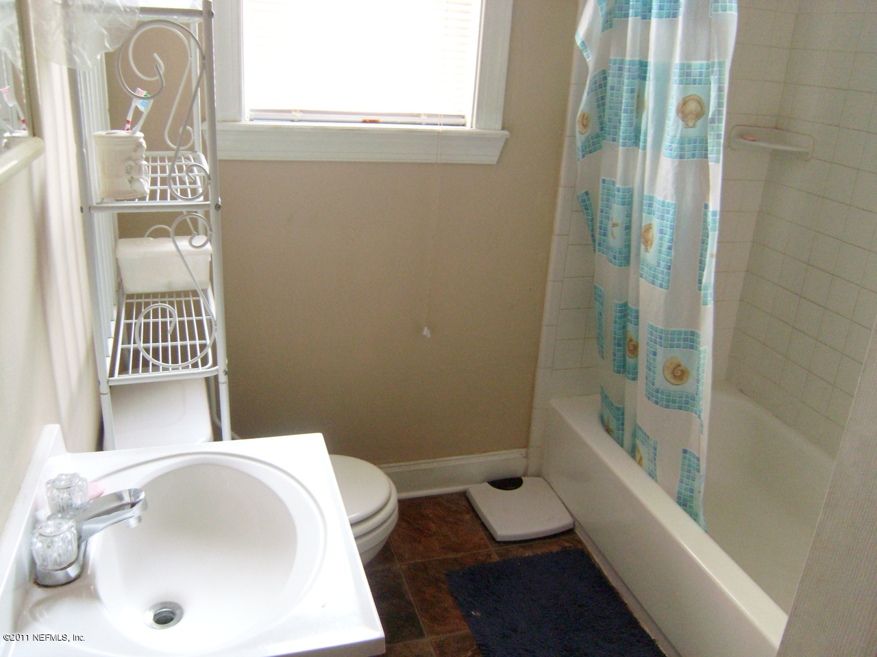 2219 Bayview Road Jacksonville, FL 32210 - Photo 10 of 11 a bathroom with a sink and bathtub with shower