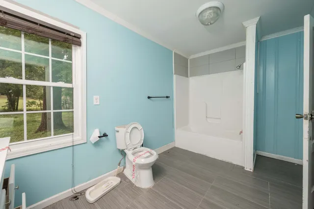 a bathroom with a toilet and a shower