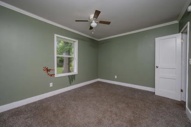 an empty room with windows and closet