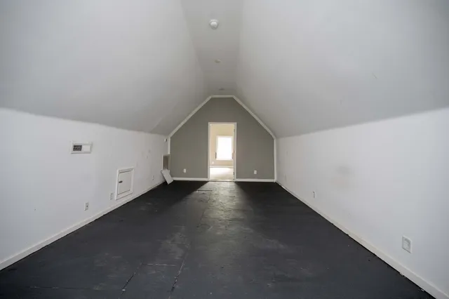 an empty room with windows and entrance