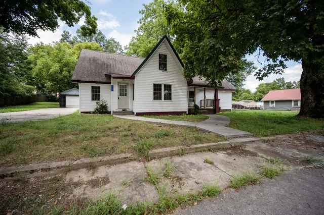 a front view of house with yard and green space
