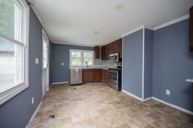 a view of a kitchen with a sink and dishwasher cabinet