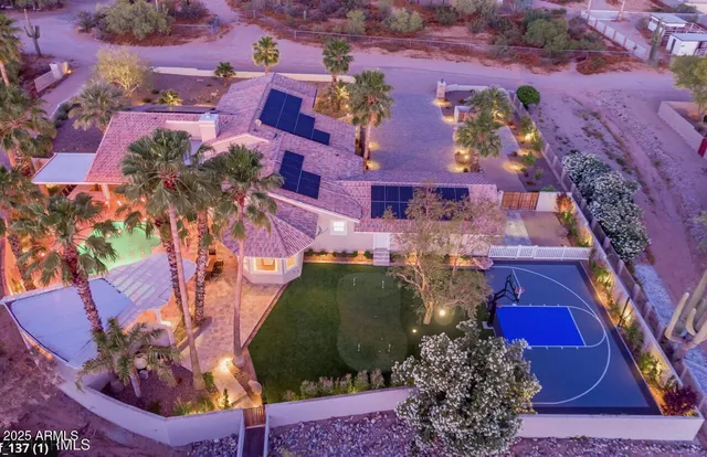 an aerial view of a house with a yard
