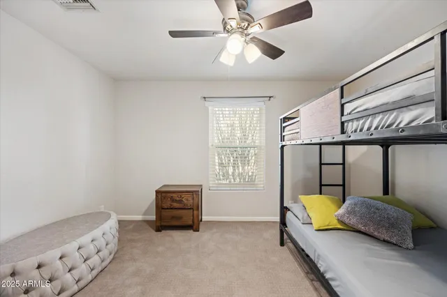 a bedroom with a bed couch and window