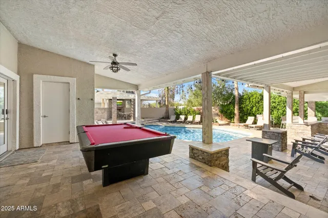 a living room with furniture a rug and a large window