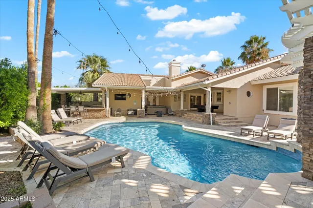 a front view of a house with swimming pool outdoor seating