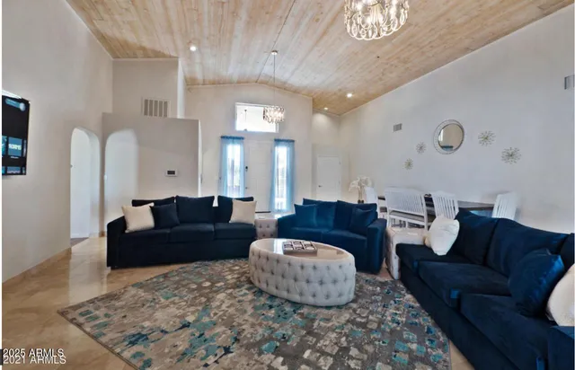 a living room with furniture and a chandelier