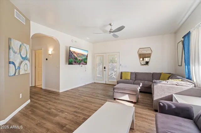 a living room with furniture and a lamp