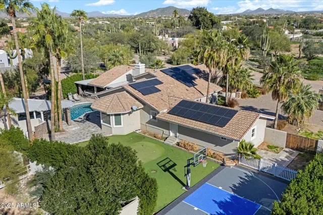 an aerial view of multiple houses with a yard