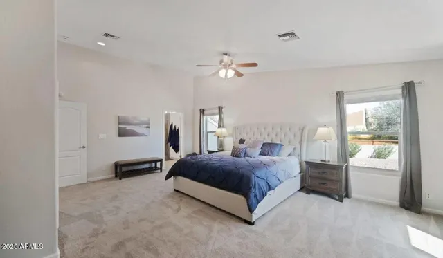a living room with a bed furniture and a window