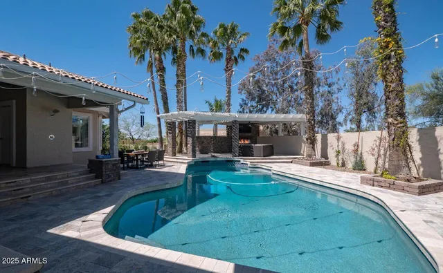 a view of a house with swimming pool and sitting area