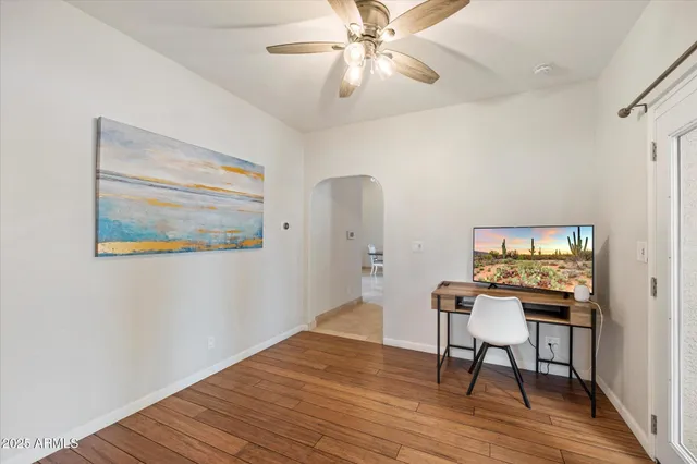 a workspace room with furniture and wooden floor