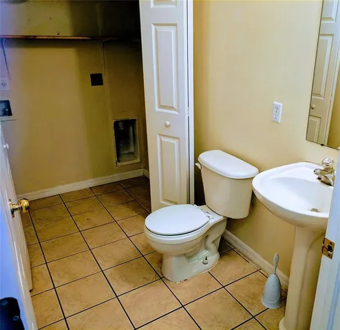 a white toilet sitting next to a bathroom sink
