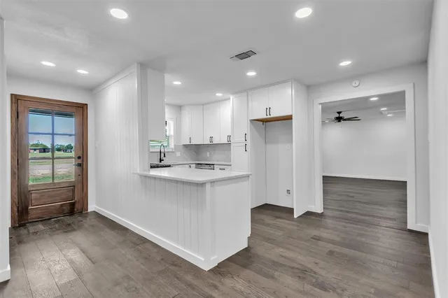 a kitchen with a sink and refrigerator