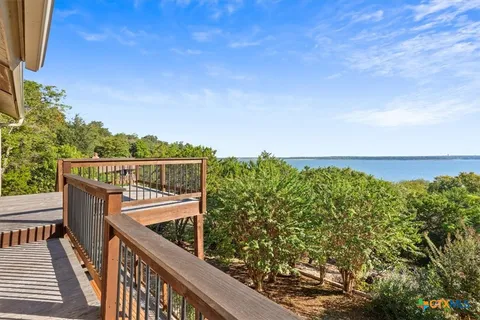a balcony with wooden floor and fence
