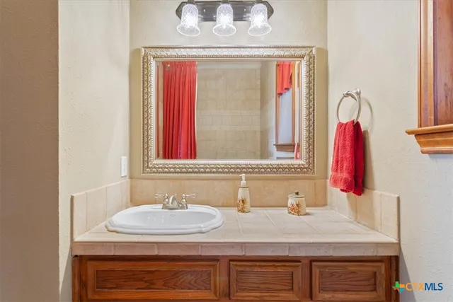 a bathroom with a sink and a mirror