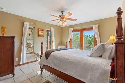 a bedroom with a bed and a large window