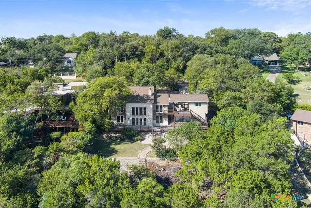 an aerial view of a house with yard and outdoor seating