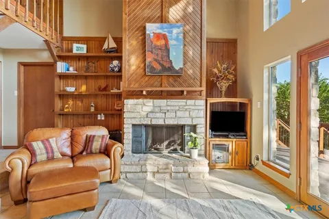 a living room with furniture a fireplace and a flat screen tv