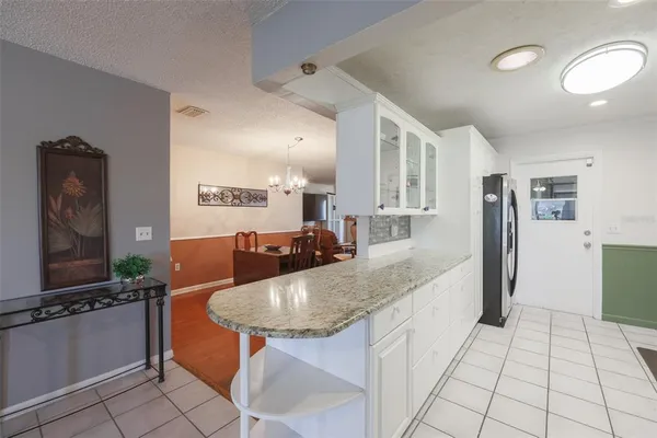 a large kitchen with kitchen island granite countertop a large counter top and appliances