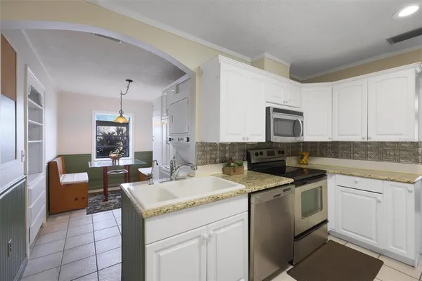 a kitchen with a sink stove and cabinets