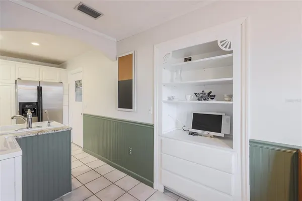 a kitchen with a sink and a mirror